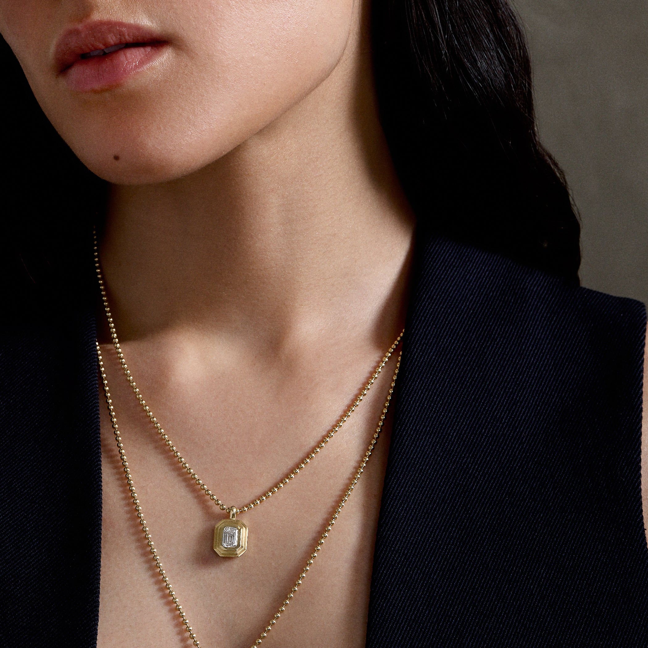 gold chain necklace with diamond emerald-cut pendant